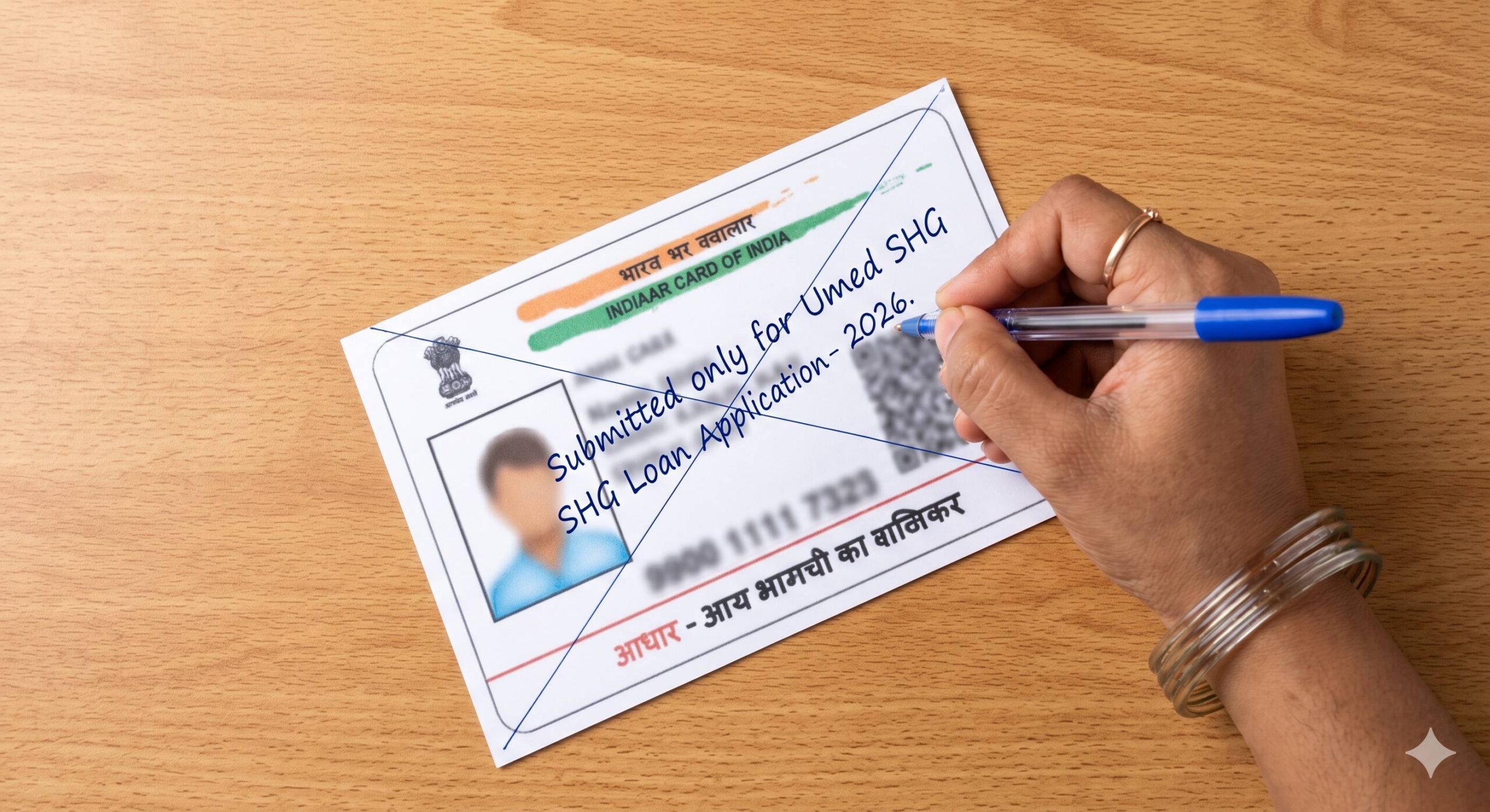 An Indian woman’s hand using a pen to safely cross out and write safety text on an Aadhaar card photocopy.
